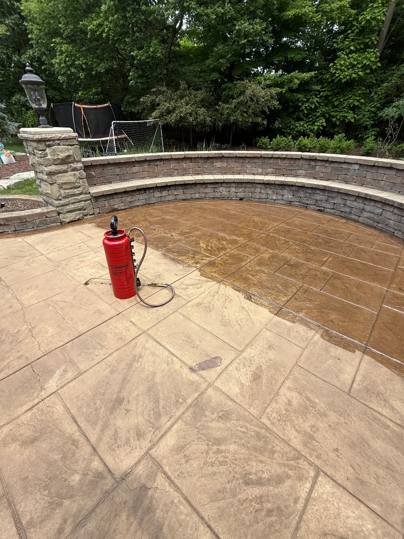 Real customer stamped patio mid-seal: dry left side, sealed right side.
