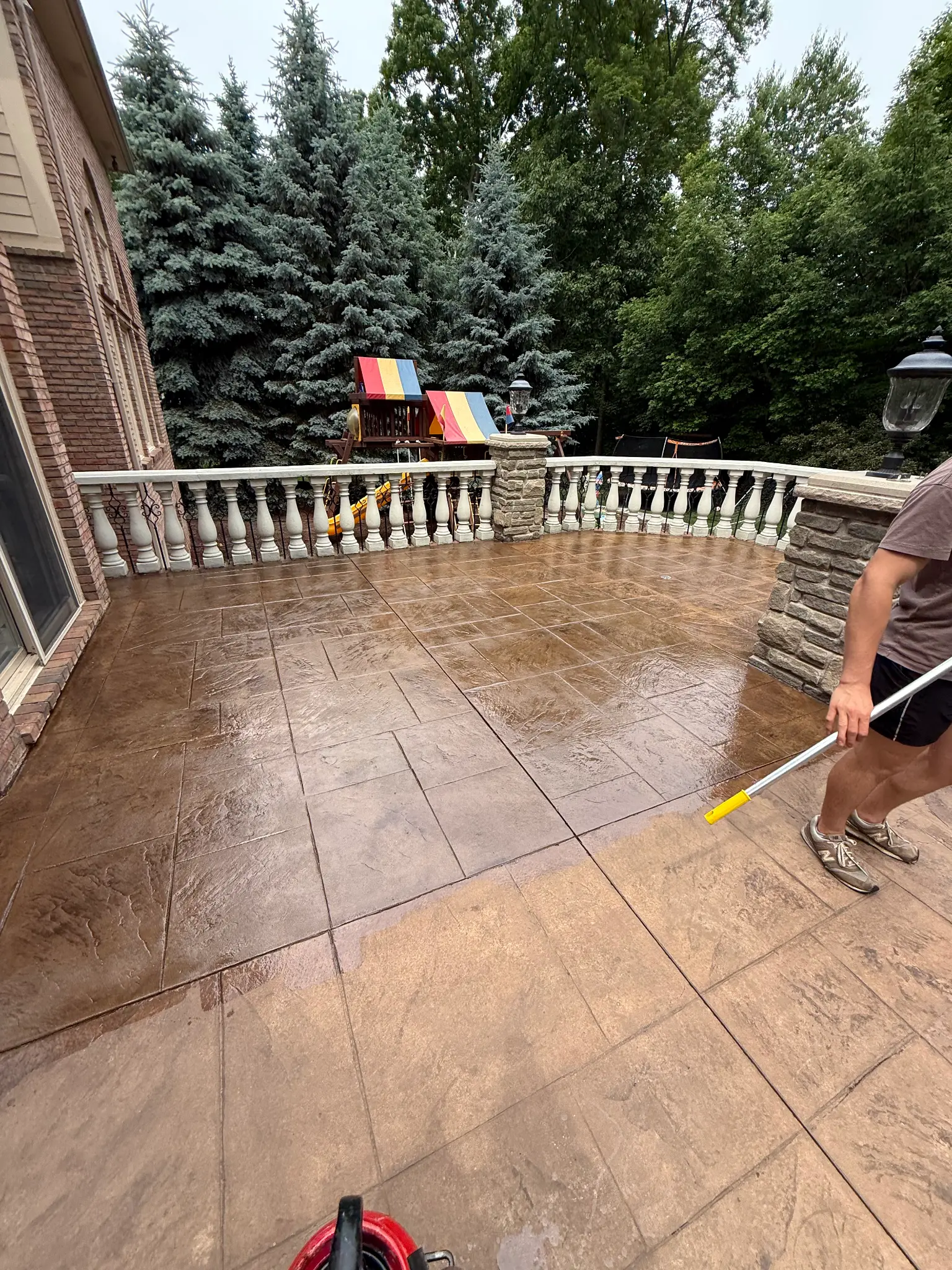 A real raised stamped concrete patio with a deep wet-look brown finish.