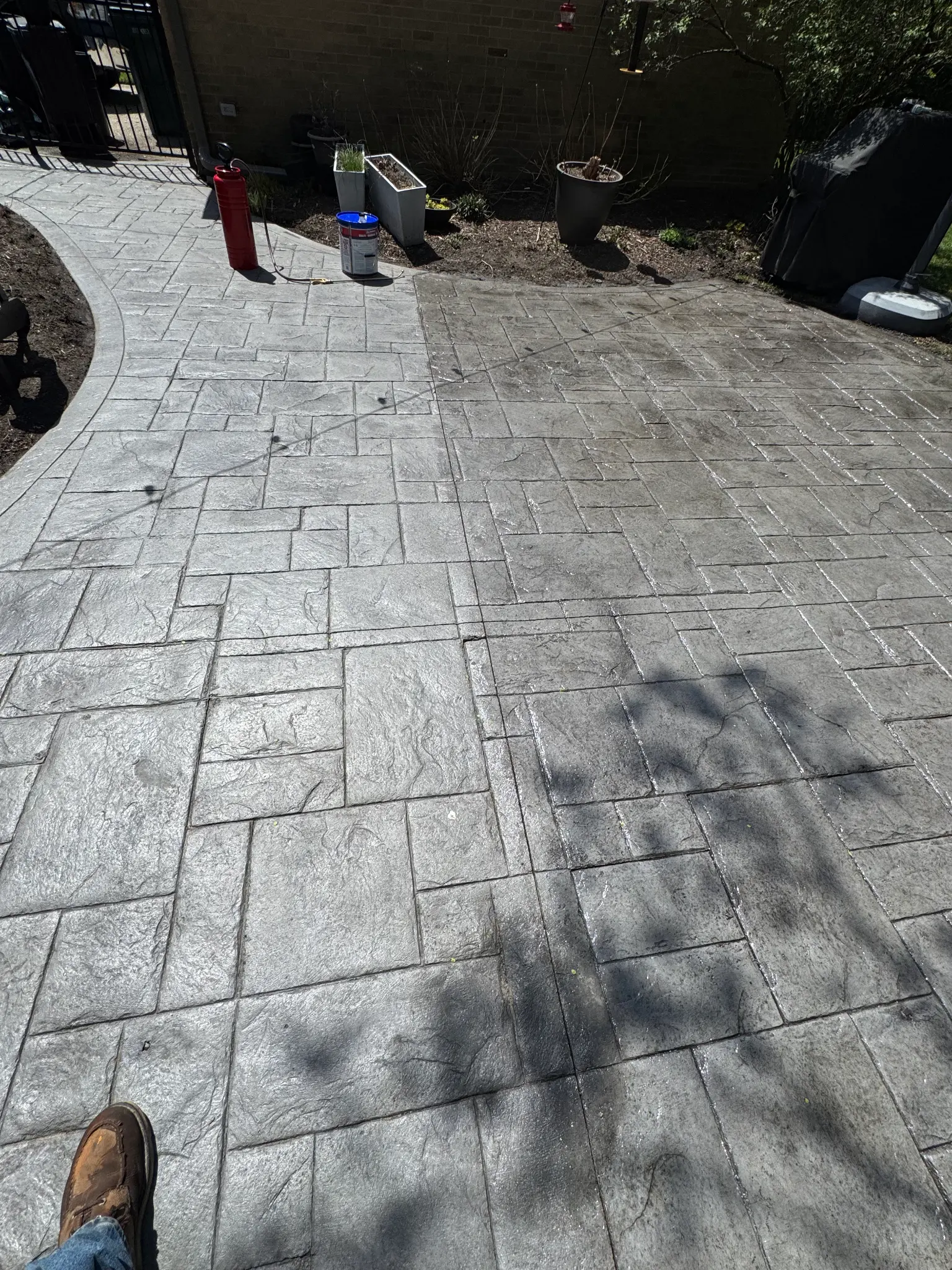 Faded grey stamped concrete that has lost its color before sealing.