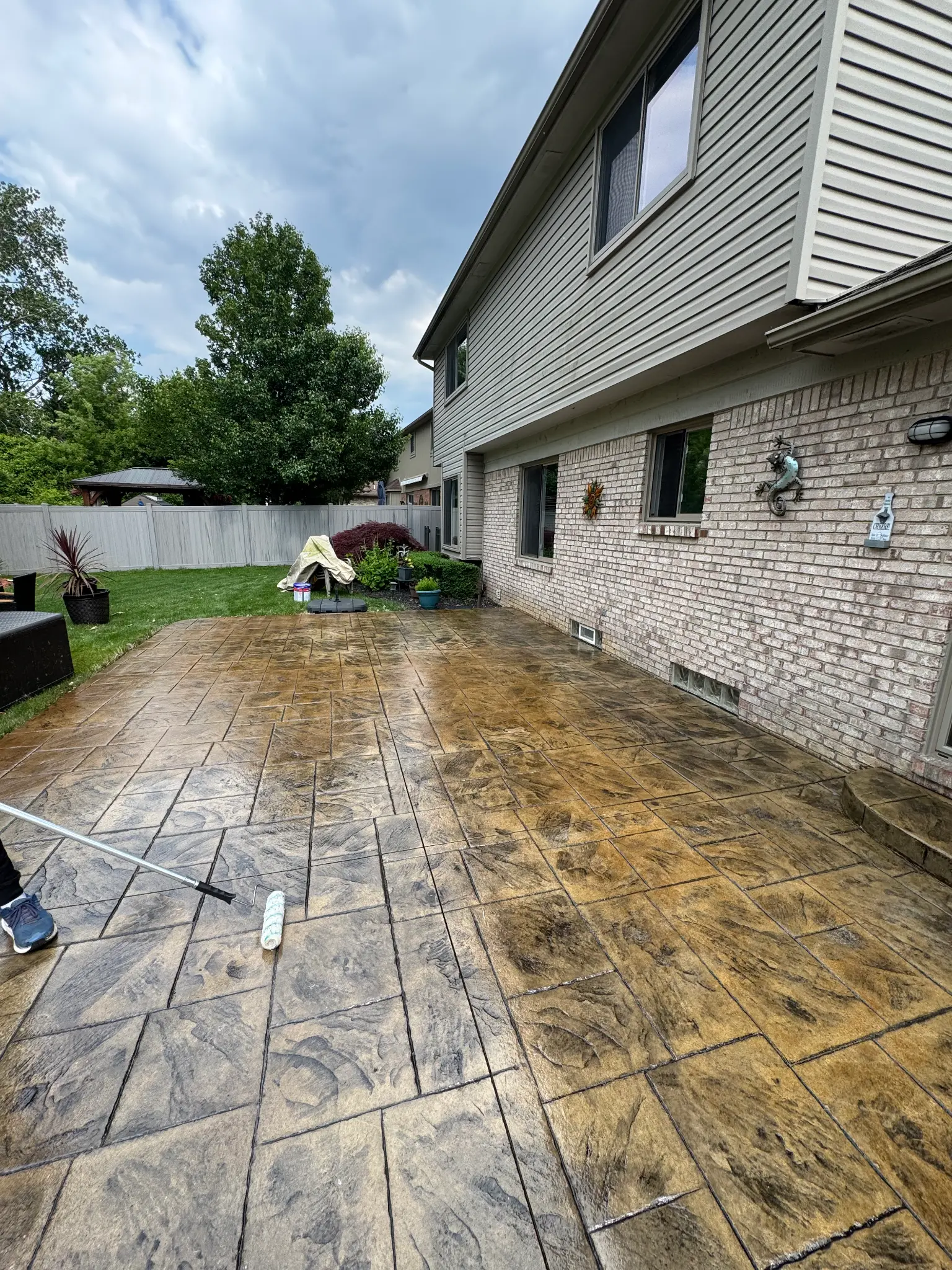 A real Austin stamped patio mid-process: cleaned, prepped, and being resealed.