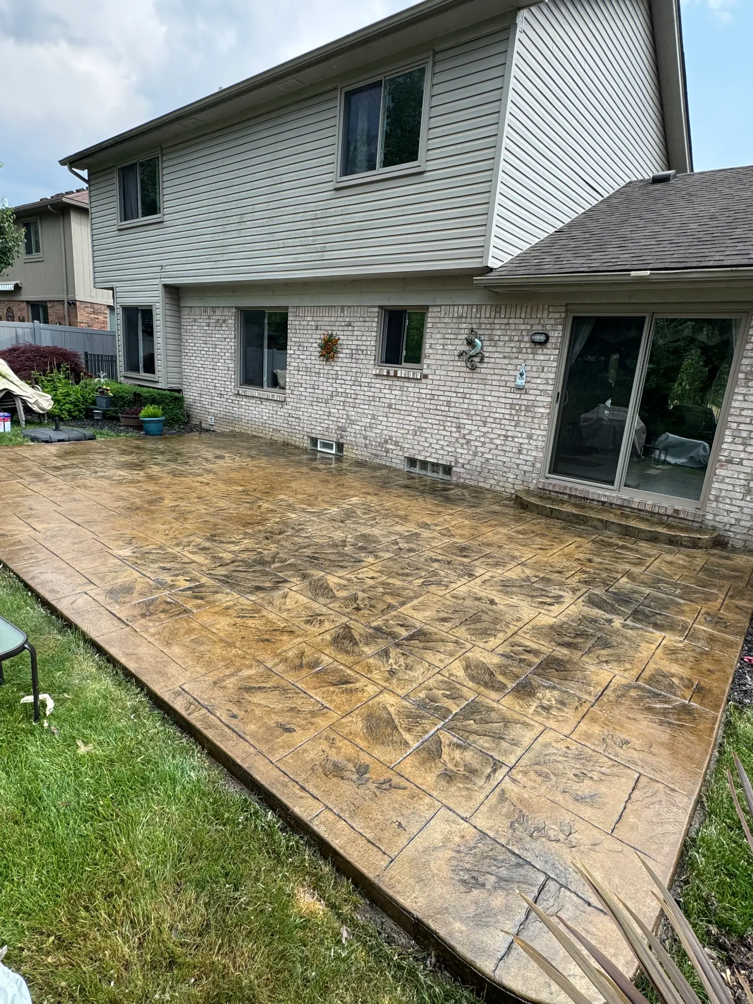 A finished, freshly sealed stamped concrete patio.