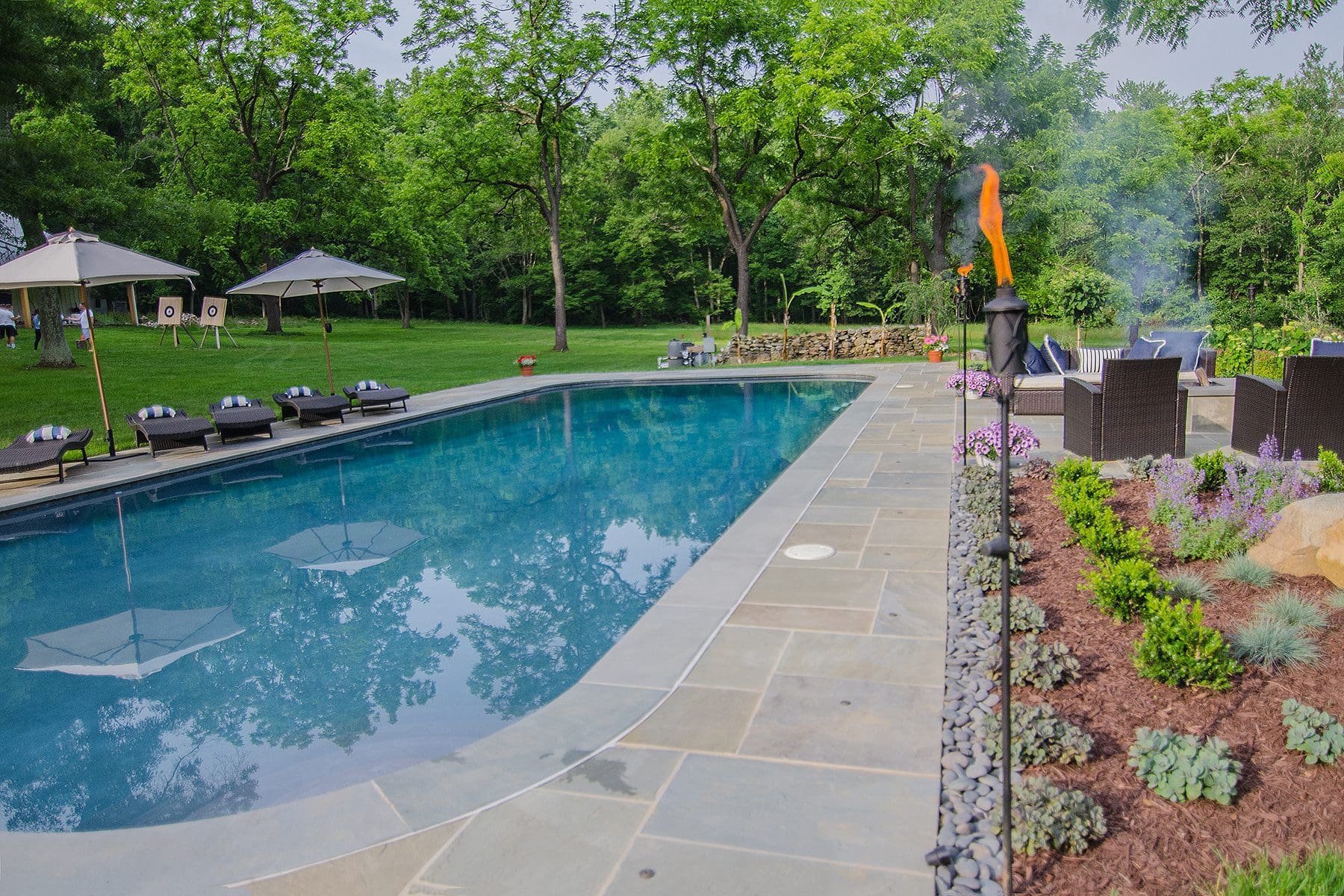 Sealed flagstone around an Austin backyard pool.